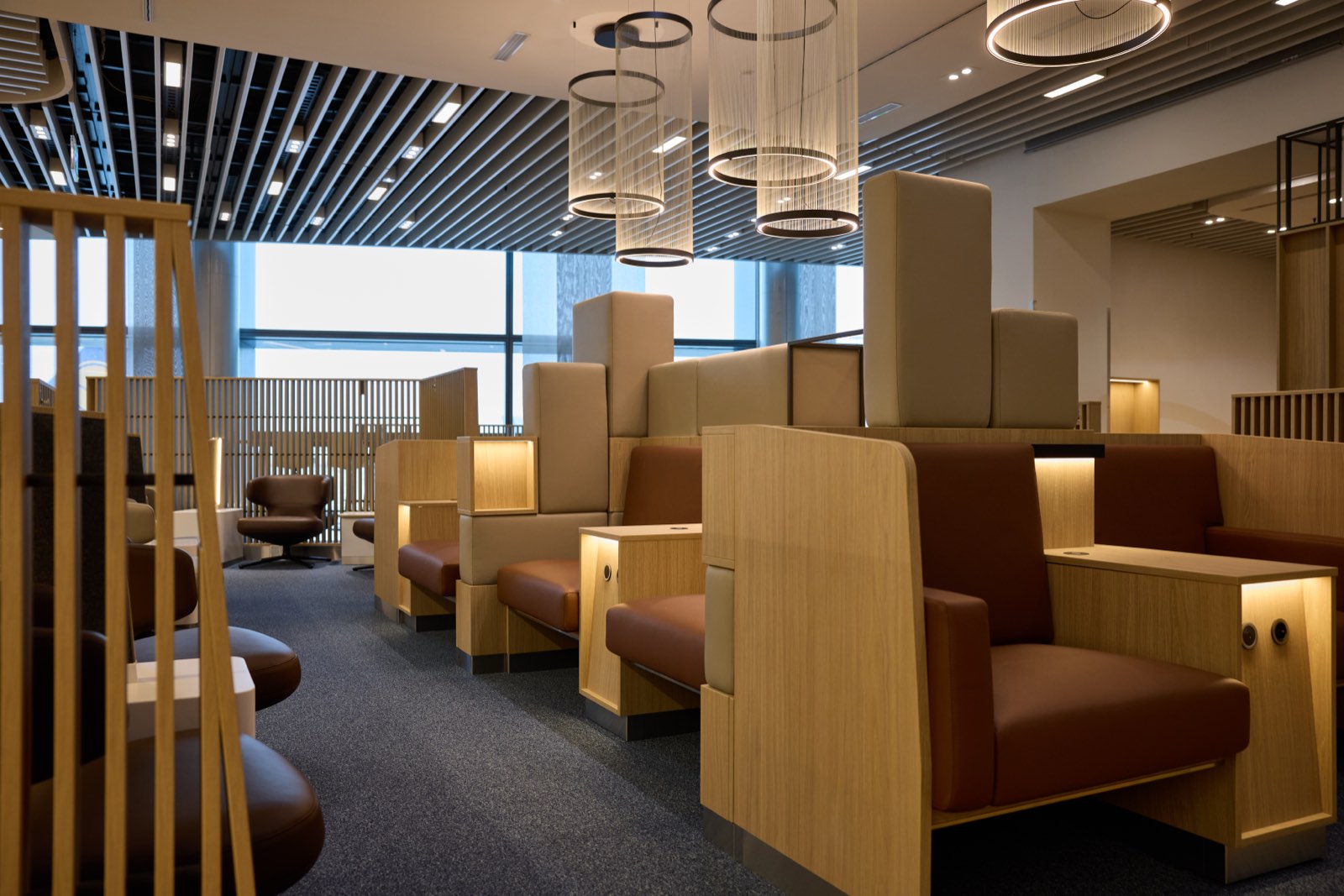 A Lufthansa business lounge at Frankfurt, with seating, low tables and a view over the pier