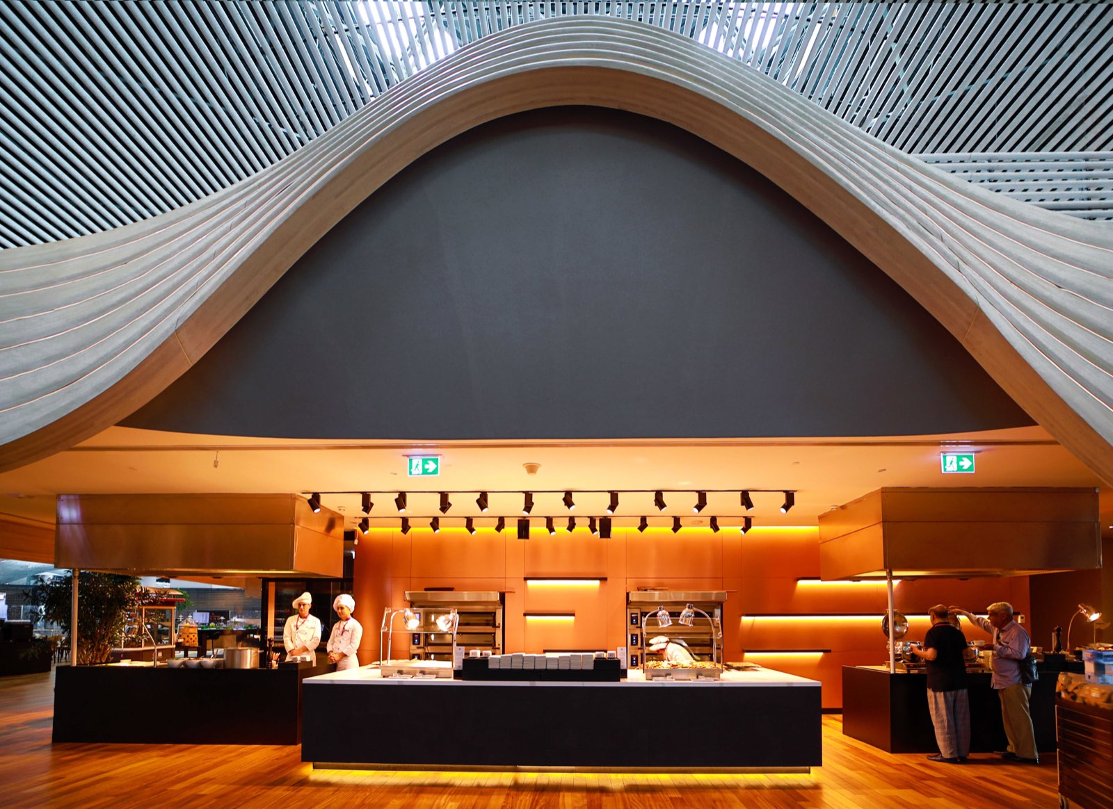 A Turkish Airlines lounge in Istanbul, armchairs and tables on a wooden floor beneath a curved ceiling